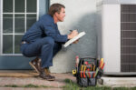 Repair man assessing AC unit