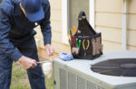 Repair man working on AC unit