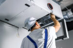 Repair man working on AC system