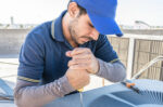 Repair man working on AC