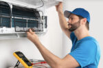 Repair man working on AC unit