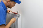 Repair man working on heater