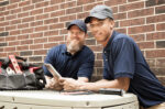 Repair man working on AC unit