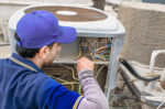 Repair man working on AC unit