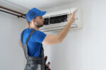 Repair man working on ductless AC