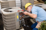 Repair man working on AC unit outside