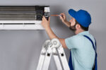 Repair man working on AC unit