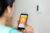 Woman viewing the thermostat temperature on her smart phone