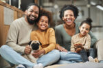 Family sitting together with small dog