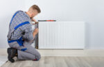 Repair man working on heater