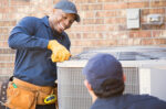 Repair men working on AC unit