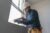 HVAC technician caulking window